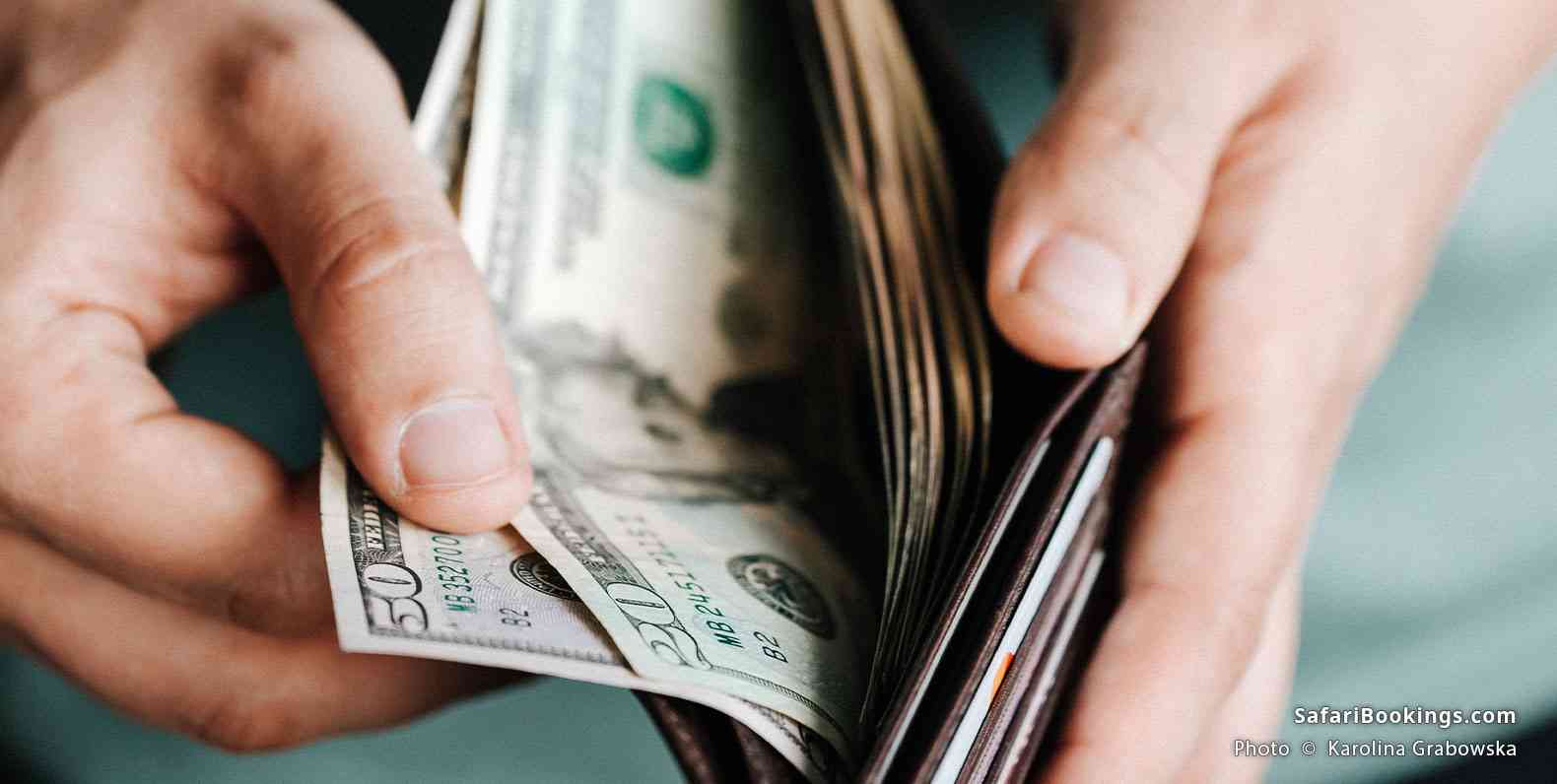 Man getting dollars from a wallet