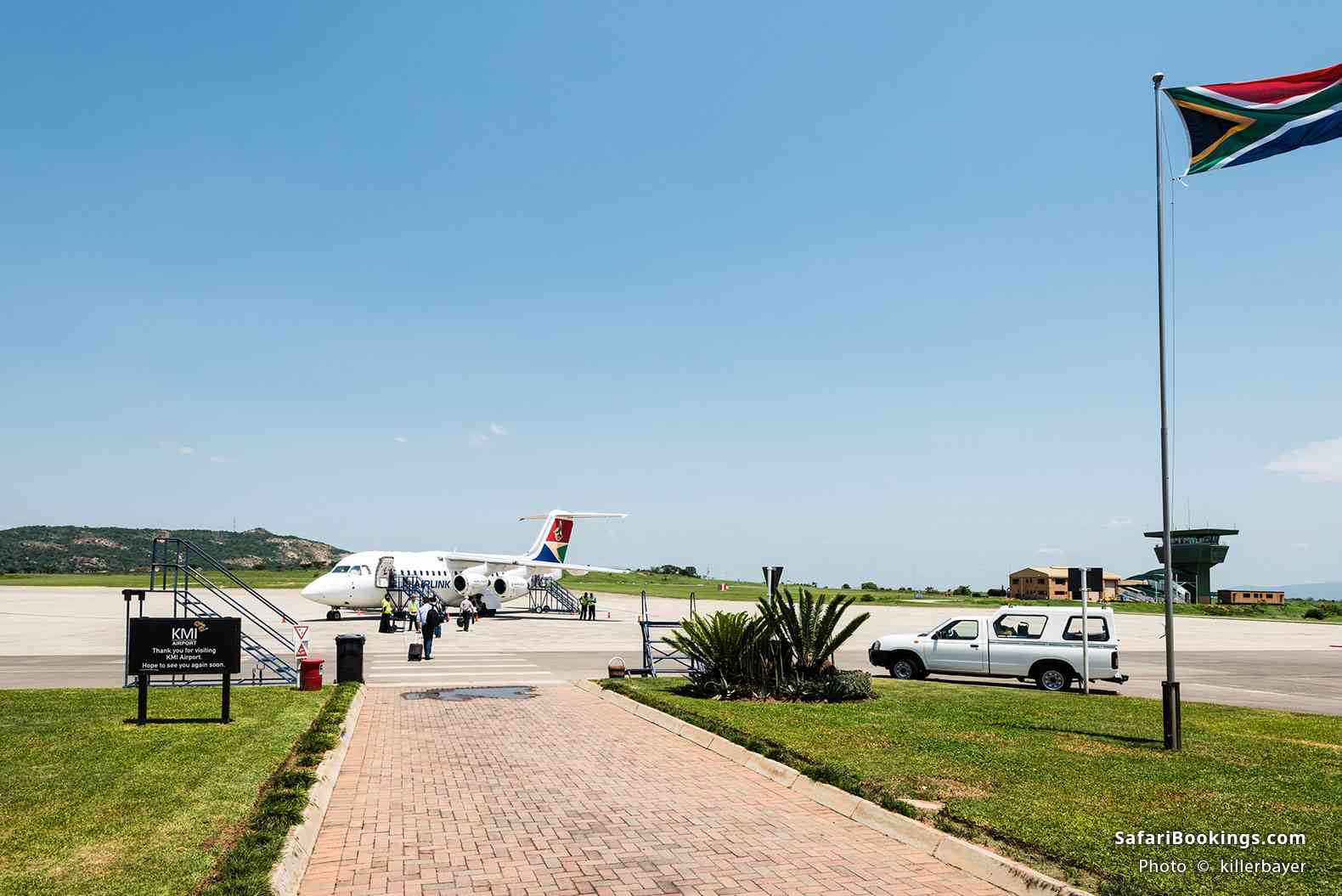 Passengers embarking the airplane on the runway of Kruger Mpumalanga Airport