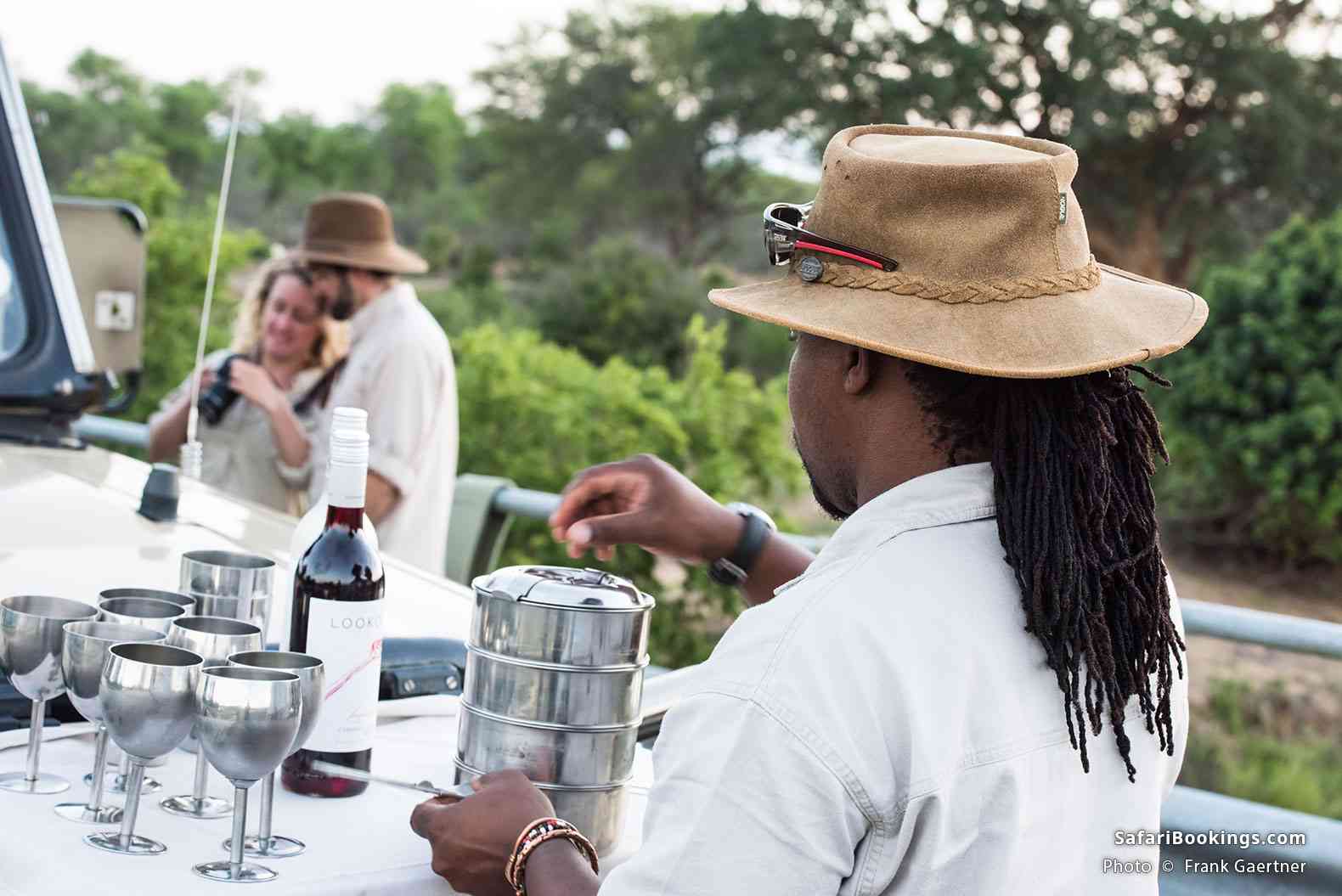 Guide preparing sundowner drinks in the bush at Kruger National Park