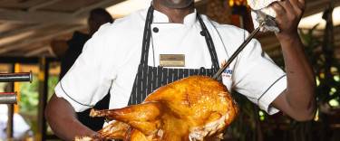 Chef carving meat at the Carnivore Restaurant