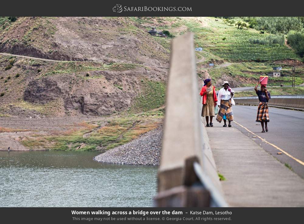 Women walking across a bridge over Katse dam in Katse Dam, Lesotho