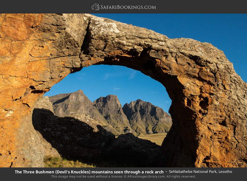 The Three Bushmen (Devil's Knuckles) mountains in Sehlabathebe NP seen through a rock arch in Sehlabathebe National Park, Lesotho