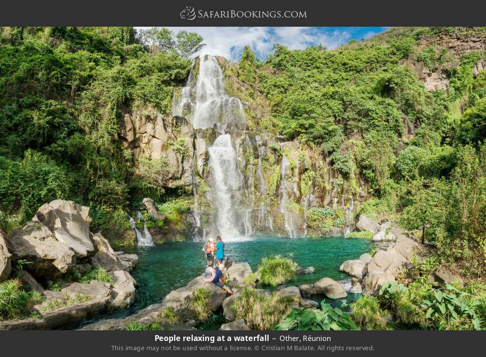 People relaxing at a waterfall in Other, Réunion