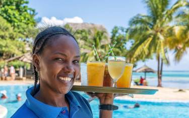 Waitress carrying drinks to the beach